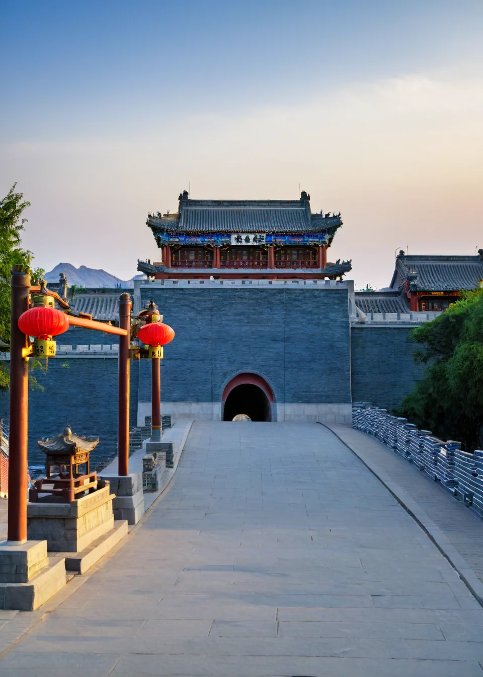 <lora:å±±æµ·å³:1>,Shanhai Pass, no humans, scenery, outdoors, sign, sky, tree, road, east asian architecture, sunset, building, architecture, pavement, sun, sunlight, street, lantern, blue sky, shadow, real world location, shrine, road sign, path, cloud, sunrise, gradient sky, stairs, fence, evening, masterpiece, best quality,