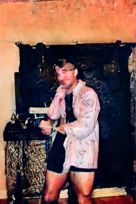 ((SFW)),  wearing a trench coat, leather gloves, and aviator goggles, light smile, mind-expanding,  sitting in office masturbating while on the phone with someone, gay porn on the computer, man surprised