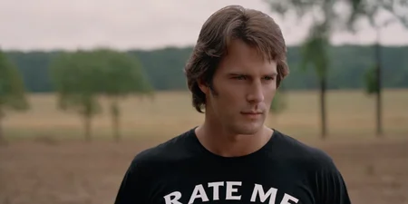 cinematic film still of <lora:cinematic vintage film:1>
a man in a black shirt with a t - shirt that says Rate Me cinematic vintage film style, shallow depth of field, vignette, highly detailed, high budget, bokeh, cinemascope, moody, epic, gorgeous, film grain, grainy