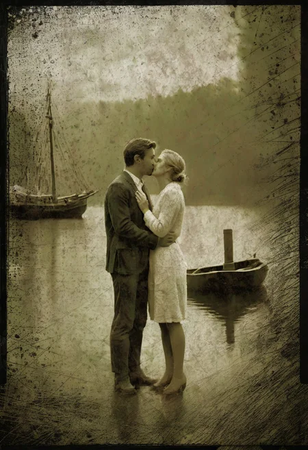 klskx , AgedSepiaCE, masterpiece, best quality, amazing quality, 1900s dock at sunset, raining, sailing schooner in background, two lovers dressed in 1920's attire, kissing in the middle of the scene, perfect composition, highly detailed background, 1man, 1woman, standing on dock, passionate romantic kiss, depth of field, ((((kissing)))), passion, love , masterpiece, best quality