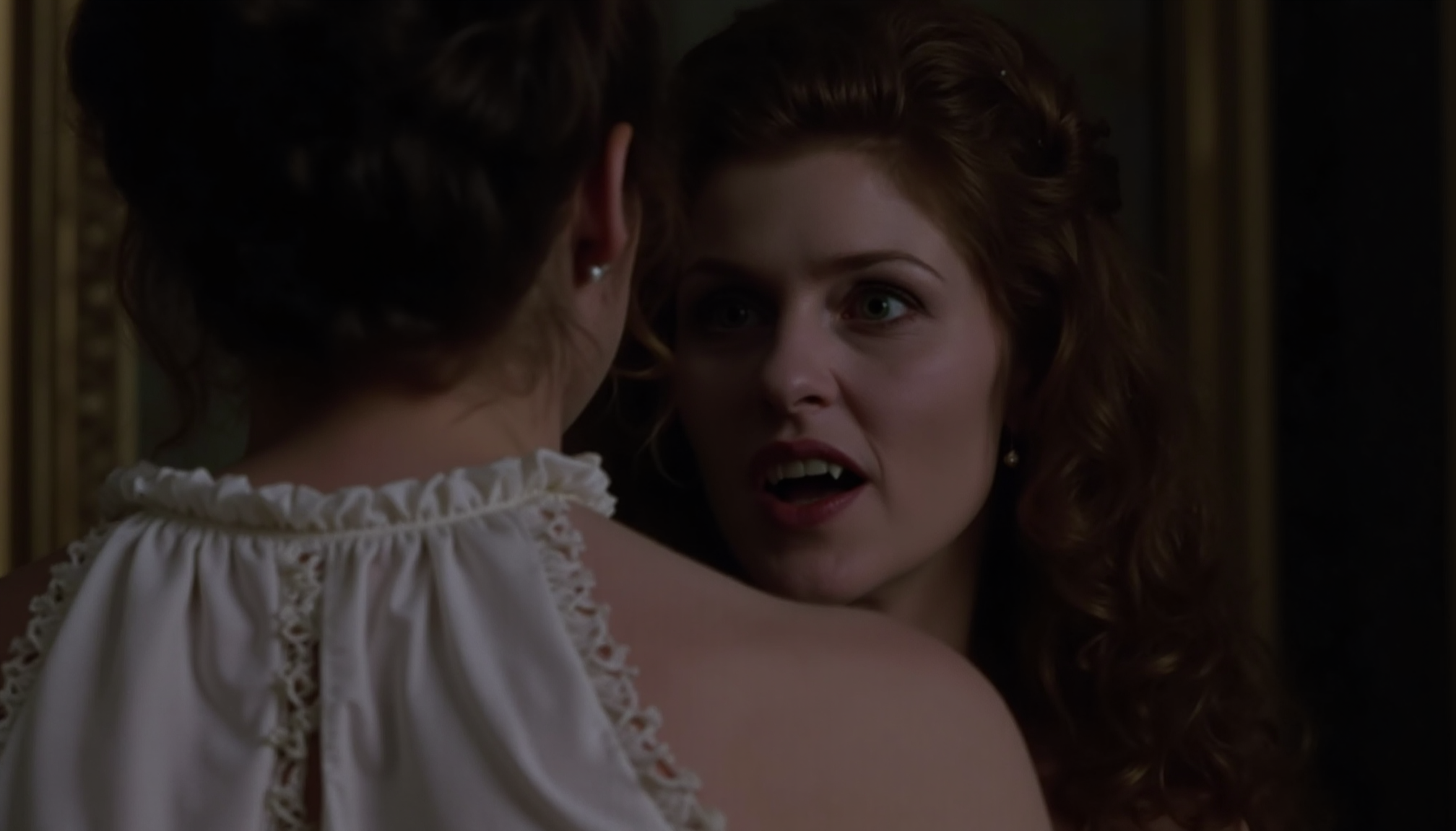 cinematic close-up shot of a vampire woman with fangs and very pale skin shown looking over the shoulder of another woman, preapring to bite, standing very close. The other woman is shown from behind, wearing a white nightgown, victorian room in background. At night in soft light. Analogue film, IMAX, photorealistic, very detailed <lora:iwtv_flux_1_0:1>