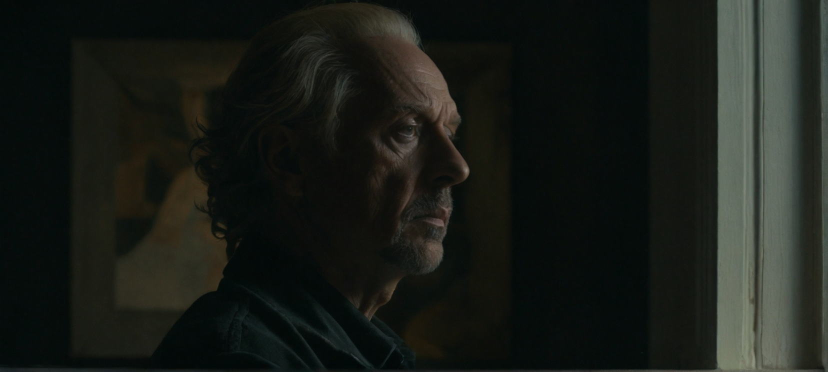 A film still portrait face focused of a reclusive artist lost in thought, abstract, moody, art-house, portrait.
