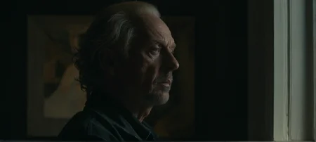 A film still portrait face focused of a reclusive artist lost in thought, abstract, moody, art-house, portrait.
