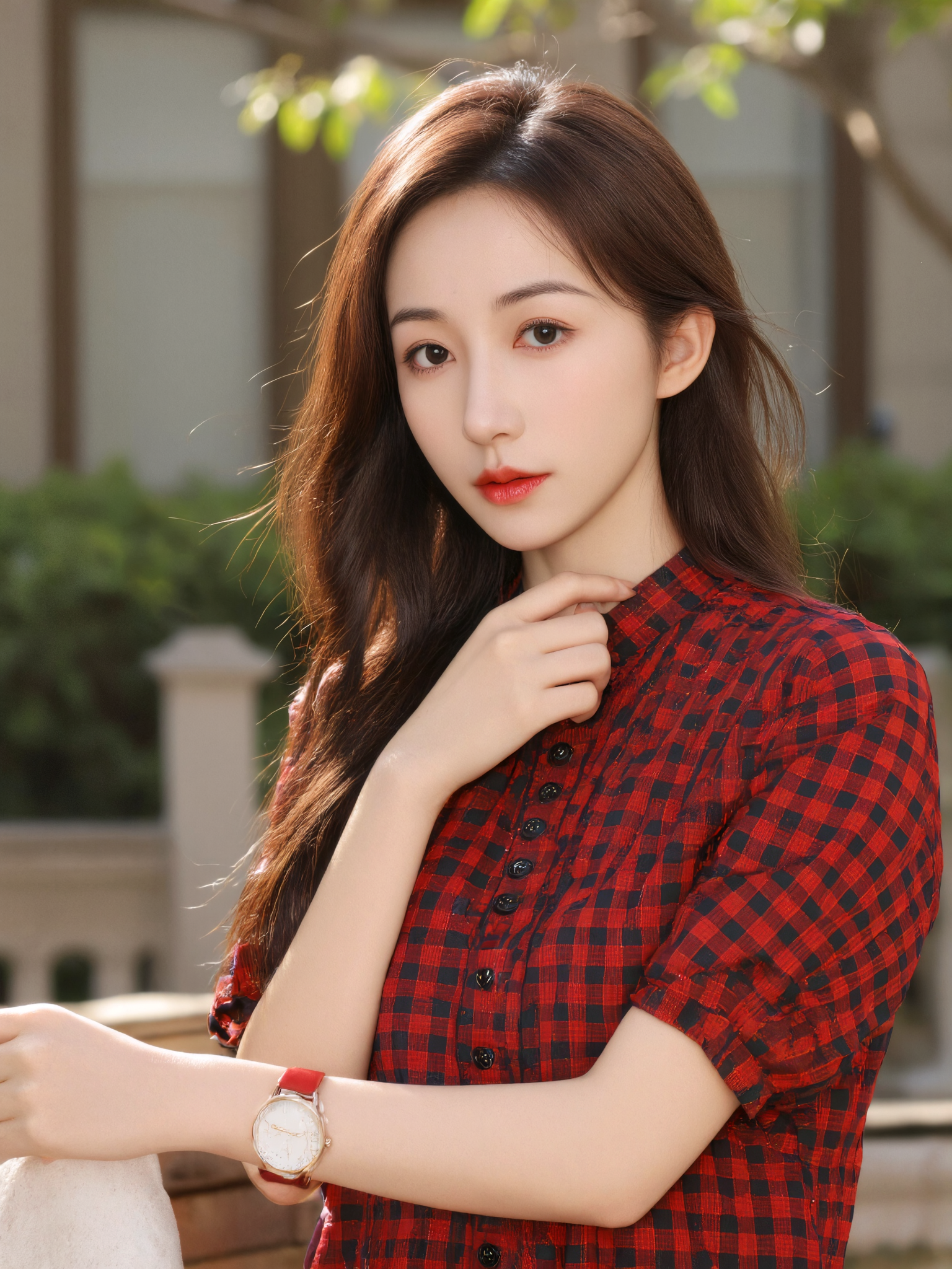 The image is a high-resolution photograph featuring an Asian woman with fair skin and long, straight, dark brown hair. She is standing outdoors, with a blurred background of greenery and a building, suggesting a park or garden setting. The lighting is natural and bright, indicating it was taken during the day. She is centered in the frame, adhering to the rule of thirds, with the camera angle slightly above eye level, giving her a confident and approachable look.

She is wearing a red and black checkered short-sleeved blouse with buttons down the front, and the blouse has a slightly loose fit, adding a casual touch to her appearance. Her left hand is resting on her neck, and she wears a red wristwatch on her left wrist. The background is softly focused, ensuring the subject remains the focal point.

The overall composition is simple yet effective, with the subject's face and upper body taking up most of the frame, and the background providing a subtle, natural context. The image is crisp and clear, with a balanced exposure that highlights the woman's features and the textures of her clothing.