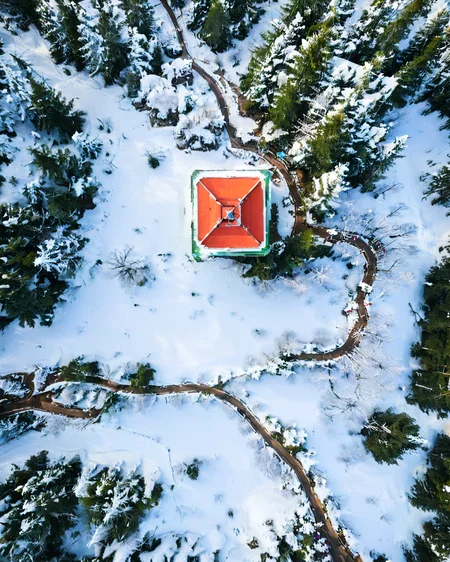 vertical perspective aerial photography, forest_walkway, winter, snowing, tower, <lora:sky:0.8>
