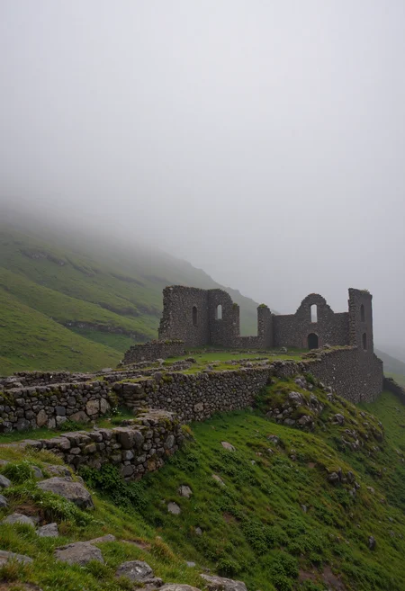 A misty morning scene, showcasing the ruins of a stone structure nestled atop a verdant hill. Low-lying fog drifts across the lush green landscape, creating an ethereal atmosphere. The stone walls are weathered and partially collapsed, hinting at age and history. The overall lighting is soft and diffused, emphasizing the moody and mysterious mood. The style should be photorealistic, with a focus on detail and depth of field. The color palette consists primarily of greens, grays, and muted browns. <lora:VividlySurrealOrigin:0.6> <lora:FluxDFaeTasticDetails:0.6> <lora:42lux-UltimateAtHome-flux-highresfix:0.25>