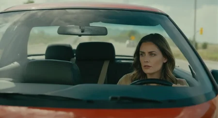 cinematic film still of <lora:Cinematic Film:1> Cinematic Film stock footage in (arri alexa style) Kodak film print, a woman sitting on a car at a stoplight Cinematic Film Style, shallow depth of field, vignette, highly detailed, high budget, bokeh, cinemascope, moody, epic, gorgeous, film grain, grainy