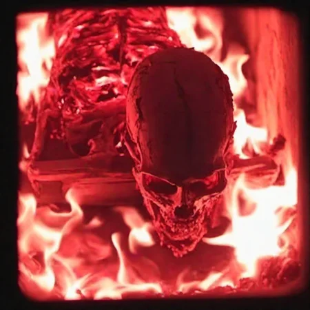 cinematic film, upright red hot glowing skul inside a (dark:1.4) crematorium <lora:crematorium-000018:1>, black background