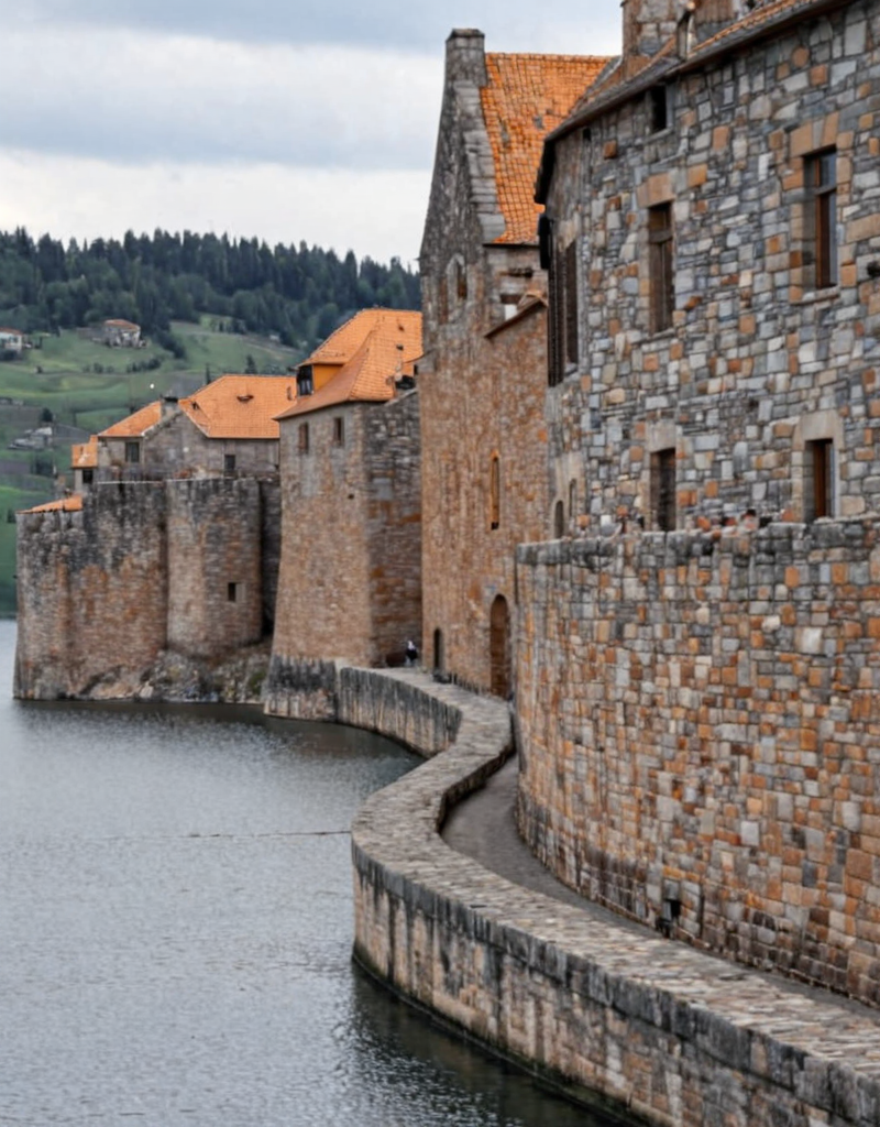 <lora:YCO_xl_F1c:1> yco_xl, fortified town, grey and orange and brown colored town wall stones, outside, in height, lake, scenery,