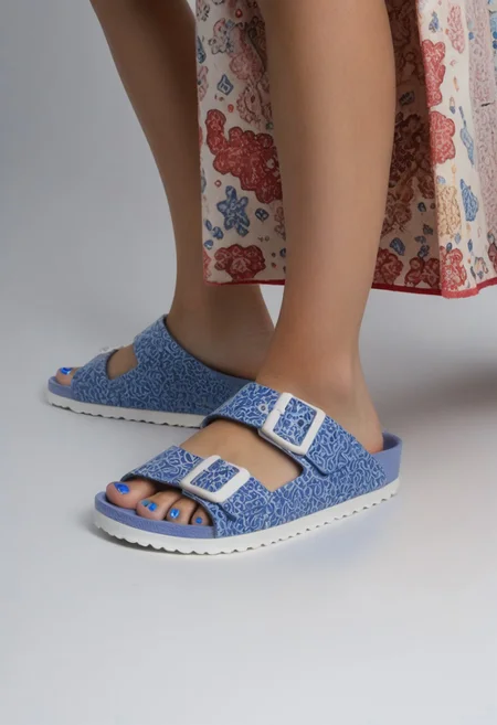 1girl, solo, simple_background, white_background, birksonfeet, blue_toenail_polish, close-up, lower_body, footwear_focus, patterned, long_skirt