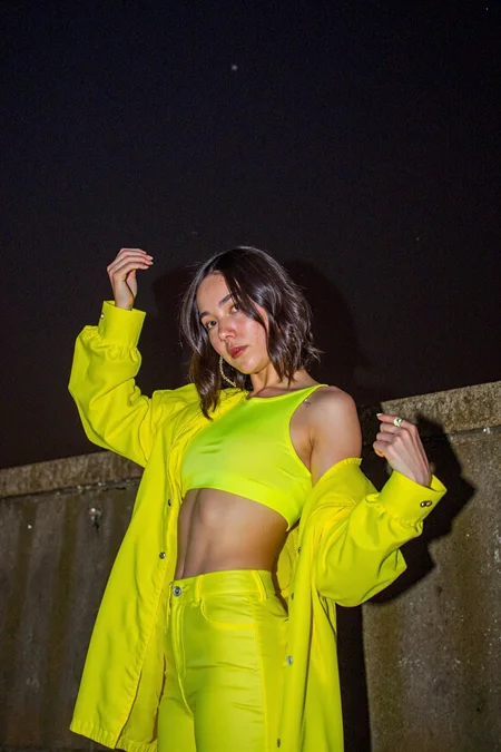 sony_a7III professional style photo, full body, y2k girl, early 20s, low angle, extravagant pose, night , outside, y2k fashion, bright clothes 2000's, Light leaks,  lens flares