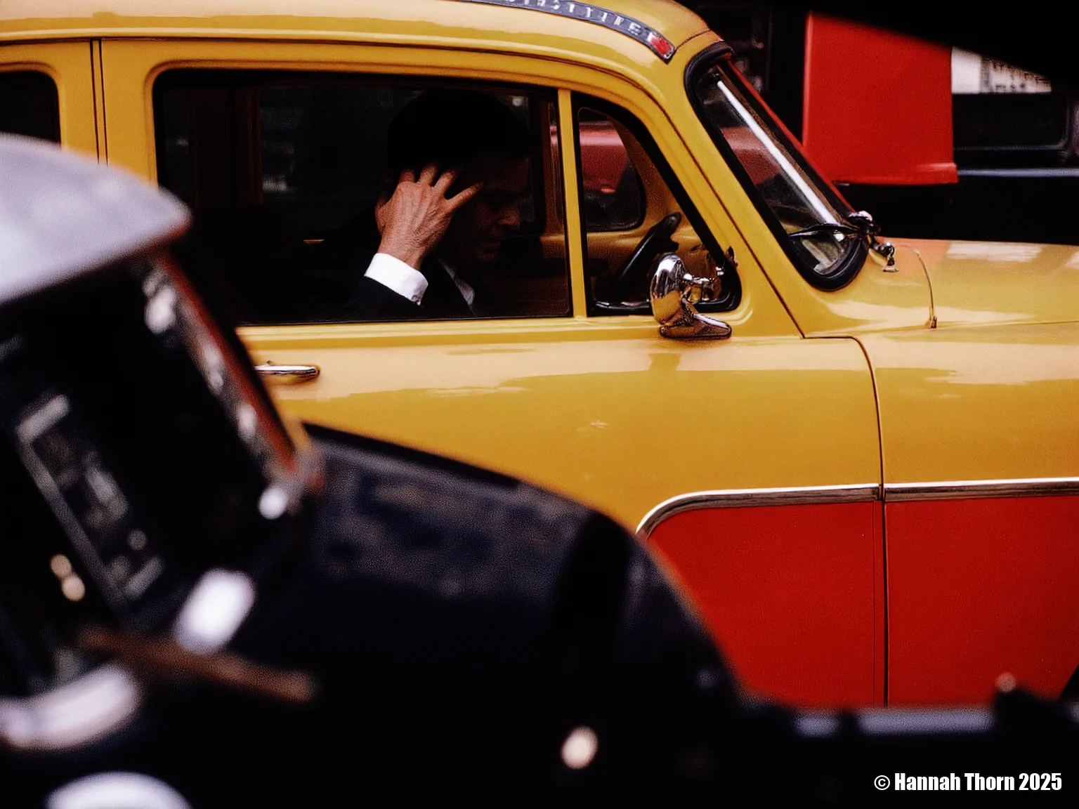 The image is a photograph, likely taken candidly on a city street. It features a vibrant yellow and red taxi, with the focus deliberately placed on a blurred foreground element, possibly another vehicle or object. Through the taxi's window, we partially see a passenger in a dark suit and white shirt, his hand raised to his face or head. The rest of his features and the background inside the taxi are obscured by shadow and the relative brightness of the window's reflection. In the bottom left corner of the image, a blurred object, potentially a cigarette, is visible, adding a further layer of urban detail. The style of the photograph is reminiscent of street photography, particularly work from the mid-20th century. It shares characteristics with the style of photographers like Saul Leiter, known for his evocative use of color, reflections, and layered compositions to capture fleeting moments of urban life. The blurred foreground element and the partially obscured subject create a sense of depth and mystery, drawing the viewer into the scene while simultaneously keeping them at a distance. The vibrant colors of the taxi contrast with the darker tones of the foreground and the shadowed interior, adding to the image's visual impact. The photograph's focus is not on sharp detail but on capturing an atmosphere and a transient moment, suggesting a snapshot of life in motion. The overall effect is one of both vibrancy and anonymity, capturing the bustle and anonymity of city life. <lora:_Flux\Saul_Leiter_Streetphotography.safetensors:1.0:1.0>