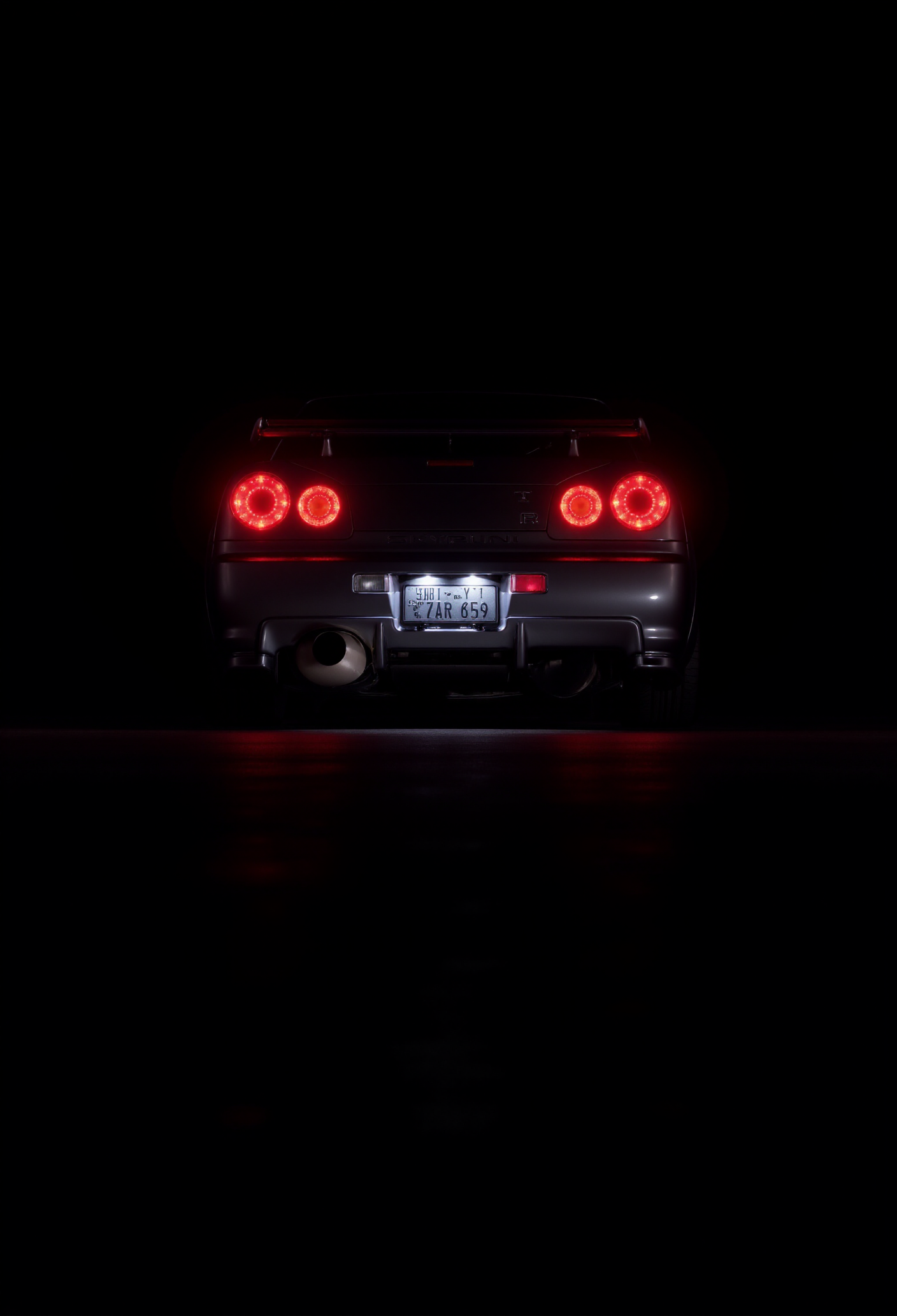 <lora:Nissan_Skyline_GT-R_R34:0.8> Nissan Skyline GT-R R34.
Rear-view low shot emphasizing the twin circular taillights of the Skyline GT-R R34, glowing with saturated crimson intensity against a pitch-black background, rear diffuser catching a faint silver gleam, with moisture beads on the bumper creating micro-reflections; the car's license plate edge lit like a relic, giving the composition an aura of ritualistic elegance.