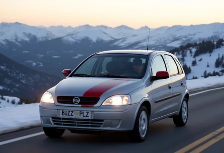 Silver with red racing stripes 2002 Chevrolet Corsa Hatchback driving in a mountain pass with snowy mountains in background during sunrise, lights on