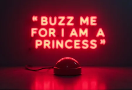 Highest_Resolution comicstyle game Show Red buzzer on table in focus blinking neon Letters over buzzer (Letters READ "BUZZ ME FOR I AM A PRINCESS")