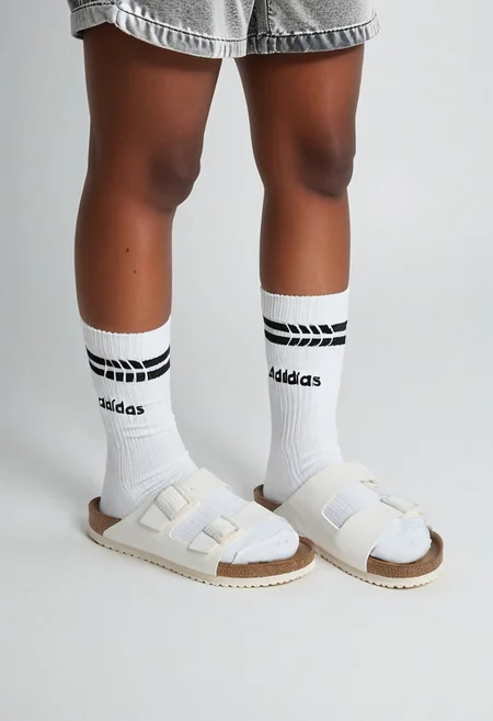 photorealistic, masterpiece, best quality.
1girl, solo, simple_background, white_background, standing.
calves, thighs, adidas_shorts, lower_body, slippers, footwear_focus, scksnsndls, birksonsocks, black_socks.