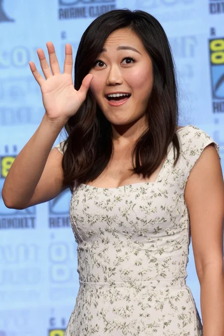 karenfukuhara, 1girl, brown eyes, standing, photo(medium), on stage, comic-con background, white floral dress, looking at someone, shocked expression, waving to someone,  cinematic lighting, photorealistic, ultra-sharp, detailed, professional photographer, black hair, blurry background, bokeh,  rule of thirds