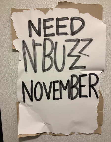 decayart, sign written "Need N-BUZZ NOVEMBER"