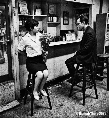 A black and white photograph from the side, taken in an indoor location, depicting a casual scene of two people sitting at a counter in a bar. a woman with short hair, wearing a white blouse and a black skirt, sitting on a stool in the middle of the image, holding a bouquet of flowers in her hand. she appears to be in her mid-twenties, with a slim body and a serious expression. to her right, a man with short, dark hair is seated on a wooden stool, facing away from the camera, with his upper body visible. he is wearing a black suit and a patterned shirt, and is looking at the woman with a contemplative expression. the bar is cluttered with various items, including bottles and a vending machine, and the floor is covered in crumpled paper. the image has a vintage feel to it, with muted colors and a slightly blurred background.<lora:_Flux\Anders_Petersen.safetensors:0.9:0.9>