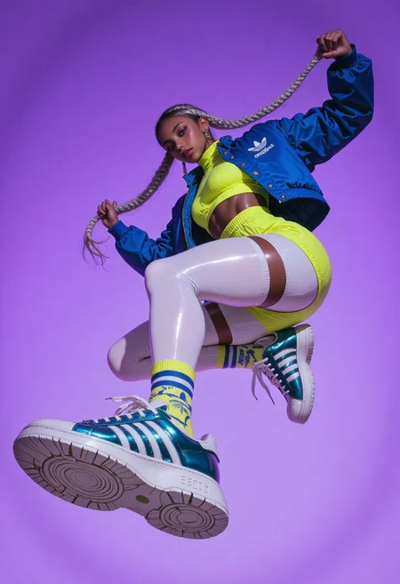 8K, Canon EOS R5, 24mm f/1.4L lens, ISO 100, ultra high-resolution, extreme low-angle fashion photograph. A young woman with a slim-yet-busty build floats midair in a vibrant urban streetwear ensemble, her pose dynamic and energetic as she grips her long, twin silver braids stretched outward. She wears a cobalt blue cropped bomber jacket with short sleeves layered over a tight lemon-yellow ribbed crop top that reveals her defined waist and prominent bossoms. Her high-rise mini skirt in neon green hugs her hips and contrasts with thigh-high, glossy white stockings. On her feet: oversized, white Adidas Superstars with thick soles and metallic teal stripes, one sneaker dramatically tilted toward the camera, displaying tread detail and bold design. Background: a smooth gradient of electric lavender fading to deep indigo, creating a striking modern contrast. The composition captures stylized motion and attitude with reflective surfaces, crisp shadows, and vibrant fashion energy. Mood: bold, youthful confidence.