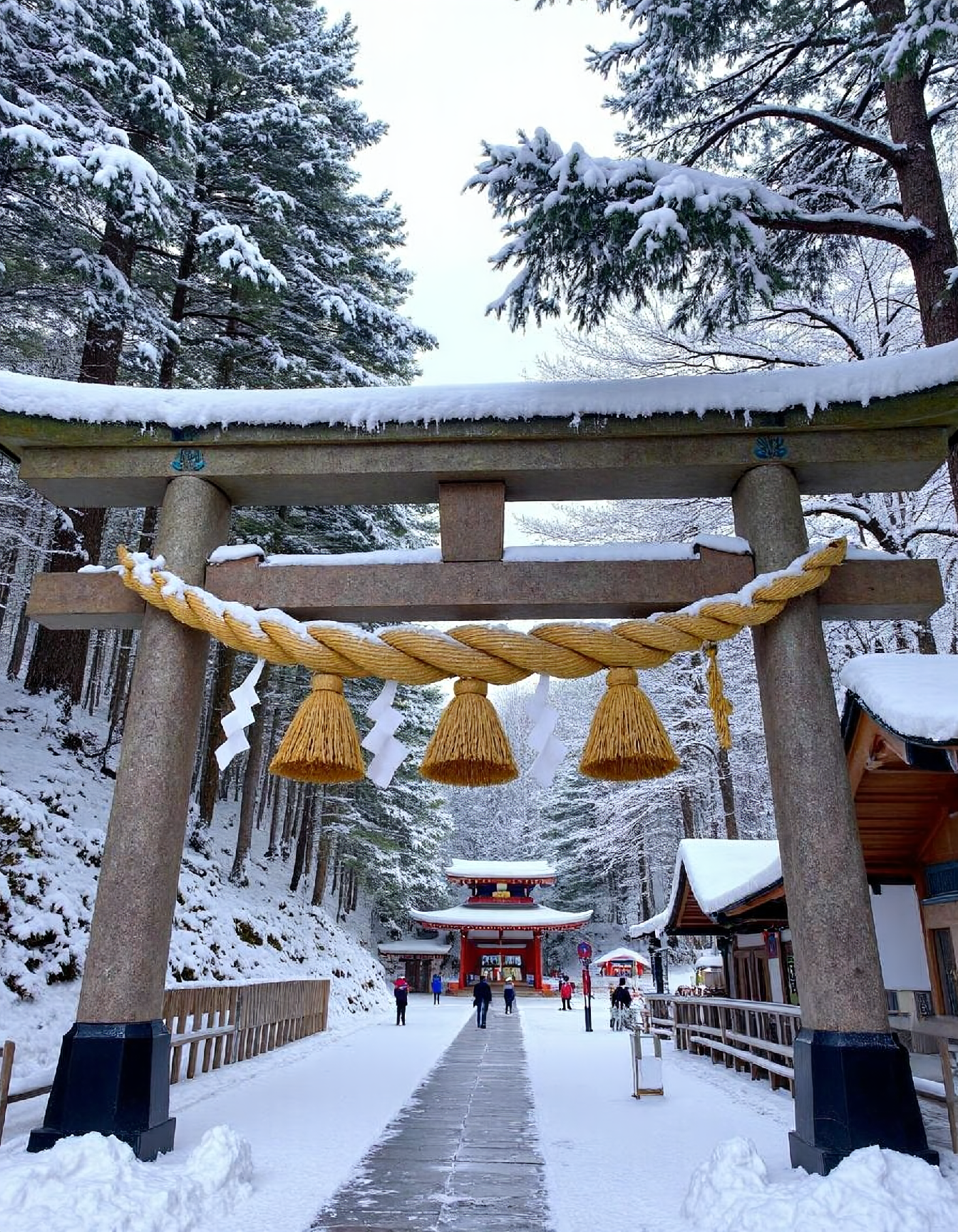 photo of a shimenawa on top of a torii gate in winter