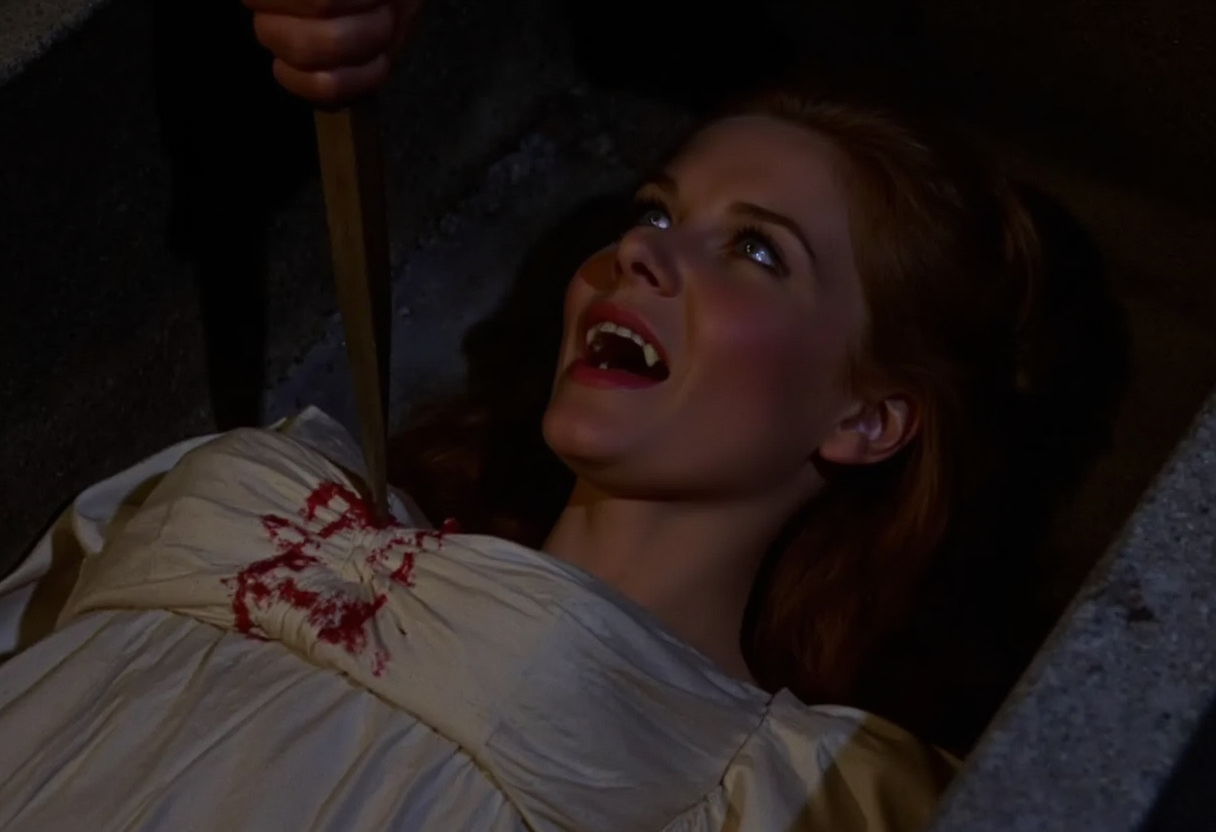 full body shot of a young vampire woman lying in a coffin, a hand is aiming a stake at her chest from off-screen , screaming showing fangs, pale skin, dark eyes, open blue eyes staring at viewer, blood running from the corners of her mouth, wearing a conservative white victorian silk gown. Soft warm light at night   <lora:hammer-000073:1>
