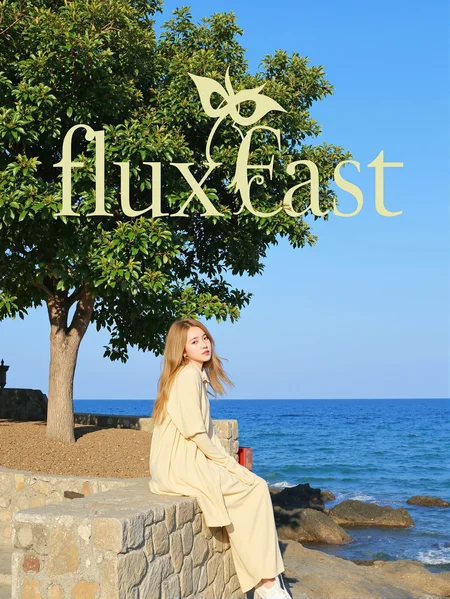 This is a highly clear and natural scenery picture with a style that depicts a female sitting on a stone wall by the sea. She is wearing a light yellow long dress and her body is facing to the right, with her legs slightly bent and her hands resting on her knees. Her eyes are gazing into the distance, as if she is lost in thought. The age of the woman cannot be determined, but judging by her appearance, she may be a middle-aged woman. She appears to be slim and is wearing a light yellow dress whose skirt is gently swaying in the wind. Her hair is golden and falls over her shoulders and back. Her eyes seem deep and her expression is calm. Her hair looks smooth and shiny, without bangs but with some curls. The background features a vast blue sea and a clear sky, along with a lush tree with deep green leaves.
There is a prominent artistic font above the picture, which reads' fluxEast 'in English