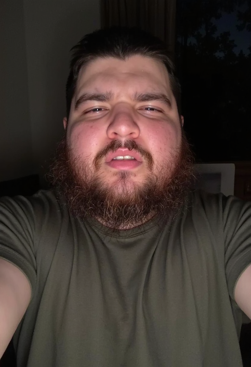 photo selfie of a 30 y.o. overweight man with a shaggy full beard, greasy impure skin, grimacing with crossed eyes, wearing a t-shirt, indoors, artificial light at night <lora:mobile-000081:1>