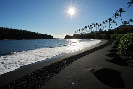 A professional wide shot photography Along a secluded Black Sand Beach in Maui where lava meets waves and proud palms stand in contrast, At late morning, (bright sun:1.1) glints on black grains, crisp palm silhouettes streak across lava stones, waves sparkle turquoise. ,, Masterpiece,best quality,realistic,HDR, 8K, masterpiece, absurdres, highly aesthetic,realistic anatomy,focus on realism and natural details, fine details