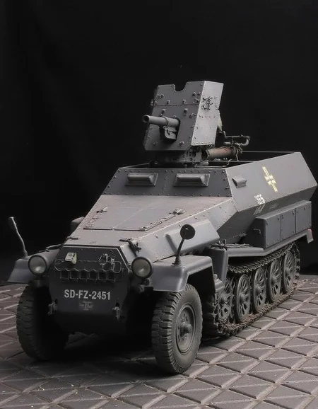 , <lora:sd-kfz-251-10:1>sd-kfz-251-10:ã
A German WWII combat vehicle equipped with a 37mm anti-tank gun on an open-top half-track.Three-quarter view.German identification mark of a cross. no humans.