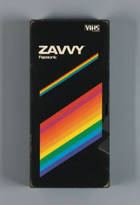 vhs-box, text focus, english text, vhs casette, "ZAVY:CHROMA" logo, rainbow stripe, vhs black case, E-180, PANASONIC, retrowave