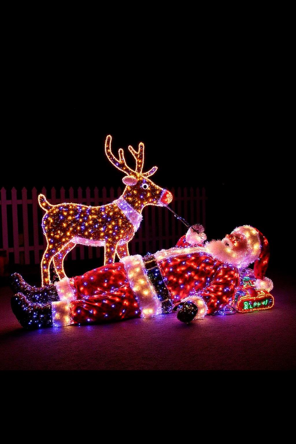 A drunk Santa lying on the street with Rudolf the red-nosed reindeer beside him. They are both wrapped in Christmas lights. Rudolf's Noise is a big Red LED shining brightly like a ambulance alarm light. <lora:xmaslight1_nocap_d6a3:1.0><lora:808042215206144851:0>