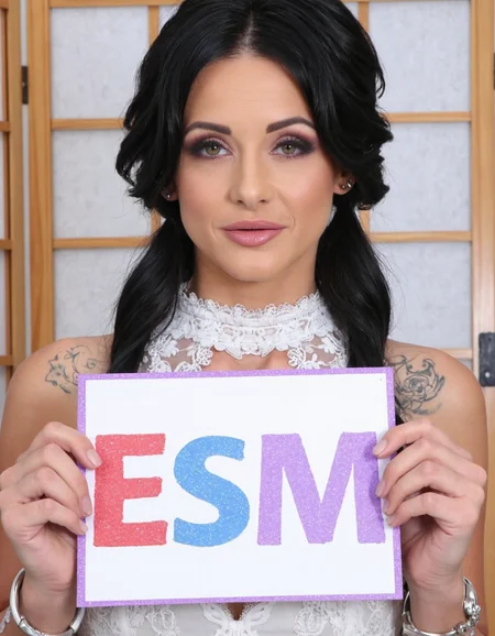High quality photo of a beautiful woman in a high neck wedding dress, the bride is holding a sign with "E S M" in red and blue letters. She is looking at viewer