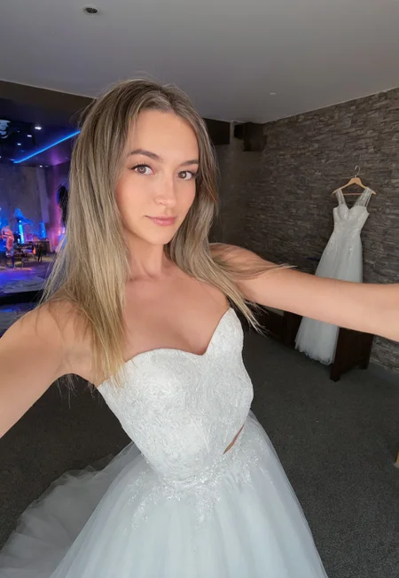 Masterpiece, detailed, realistic, photorealistic, negativeXL_D, sdxl_cyberrealistic_simpleneg, 1girl, detailed face, cute, mid twenties, small breasts, rave clothes, long hair, blonde highlights,wide angle interior background, wide angle exterior background, wedding dress