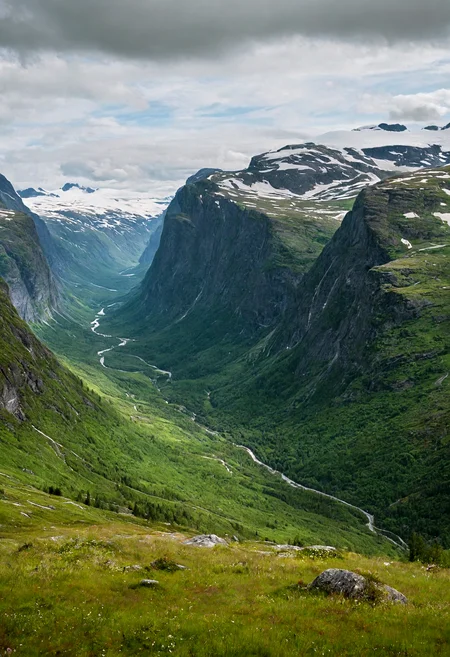 A vast green Norwegian mountain valley, dotted with trees, tall grass, tall snowcapped mountains <lora:add-detail-xl:1.5>