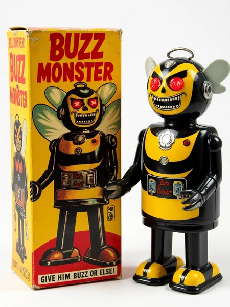 <lora:Wiz-Vintage_Toy_Robot_Packaging:1>,
Vintage toy packaging with tin toy standing next to it. The name reads "BUZZ MONSTER", with a small text below that say "GIVE HIM BUZZ OR ELSE!". 
Evil robot bumble bee with a menacing expression, featuring sharp teeth, glowing red eyes, and a mechanical face. 
He wears a black and yellow bumble bee costume with sharp edges.