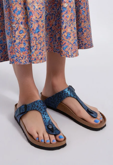 1girl, solo, simple_background, white_background, gizehonfeet, blue_toenail_polish, close-up, lower_body, footwear_focus, patterned, long_skirt