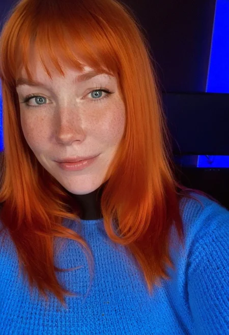 fair skin with freckles, long hair, very long hair, orange hair with a reddish tint, straight hairstyle, bangs,
cool artificial lighting, wearing a bright blue knit sweater, bright blue eyes, medium-length brown hair, wearing a black high-neck sweater, 
light smile with a hint of contemplation.
