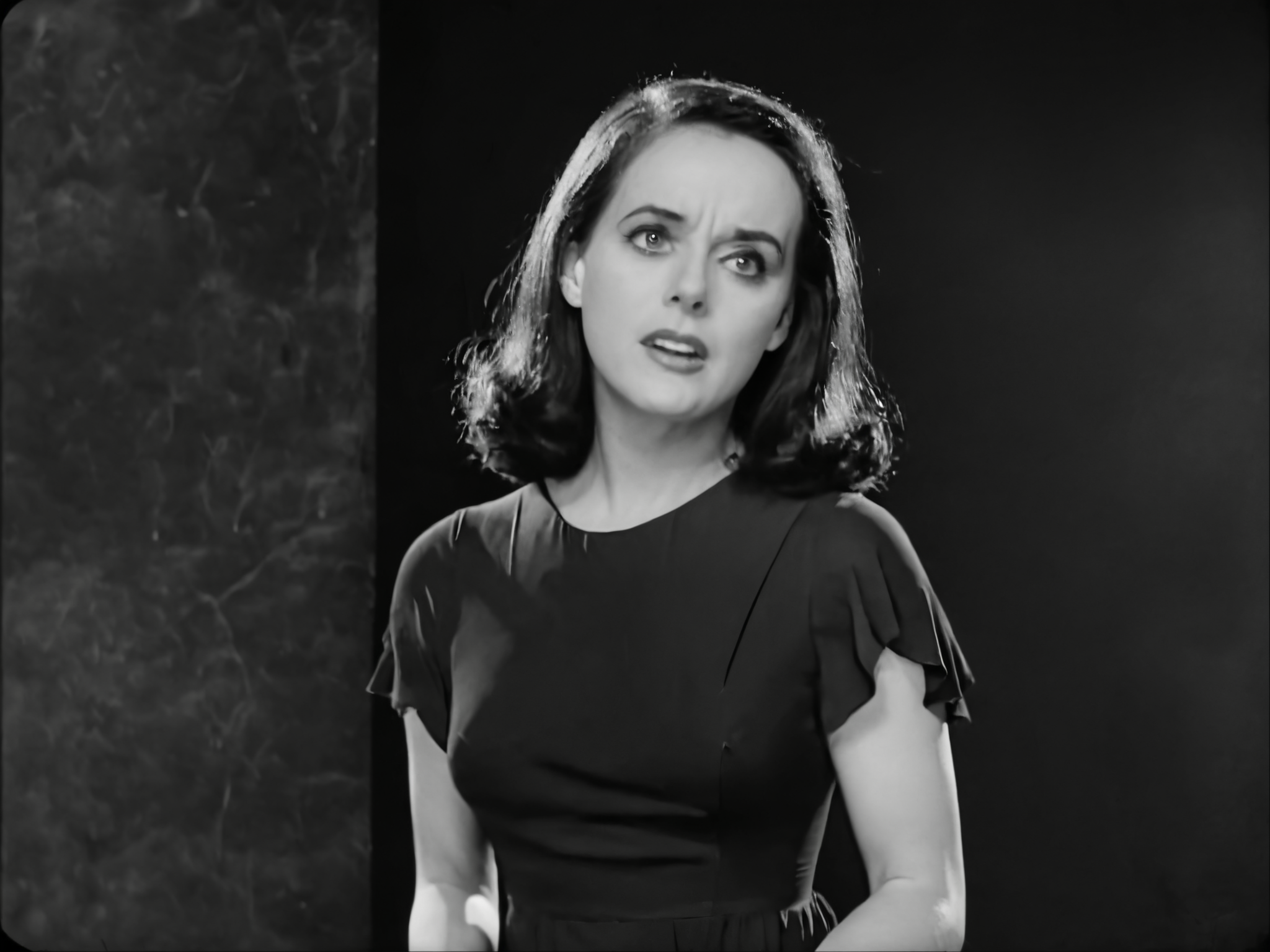 A Black and White Movie Still, A woman wearing a black dress, black hair, dark background