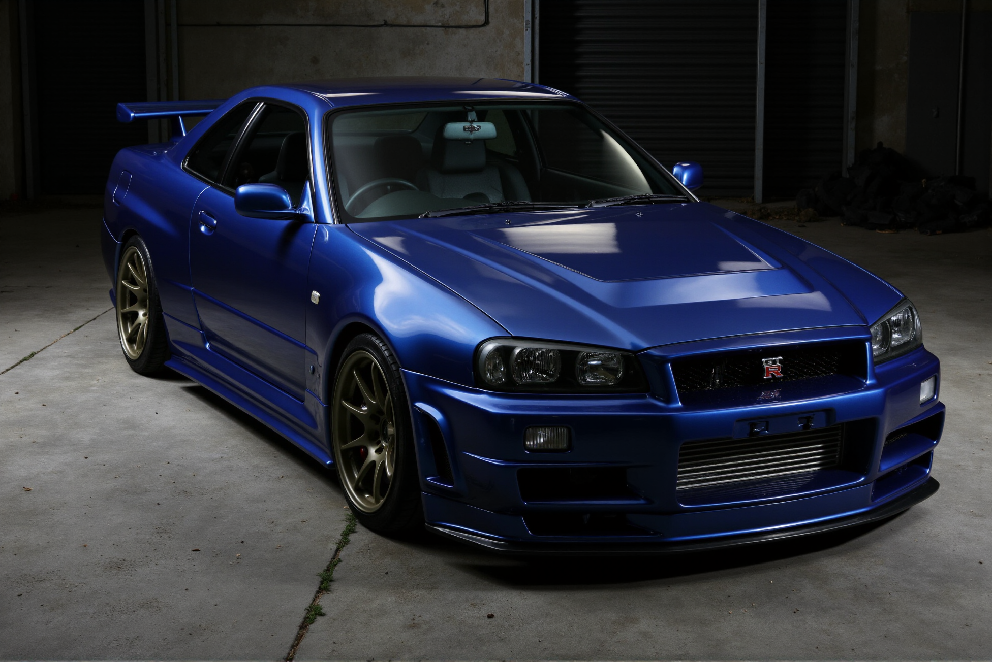 <lora:Nissan_Skyline_GT-R_R34:0.85> Nissan Skyline GT-R R34 from '90.
Industrial Edge. Set against a modern industrial backdrop, the Nissan Skyline GT-R R34 is showcased from a low isometric angle, highlighting its aggressive lines and muscular stance. The high-contrast lighting casts dramatic shadows, emphasizing the car's bold design and high-gloss finish. The composition exudes a sense of power and precision, capturing the essence of high-performance engineering.â  (Extremely shiny and reflective high gloss finish with bright glints:1.2).