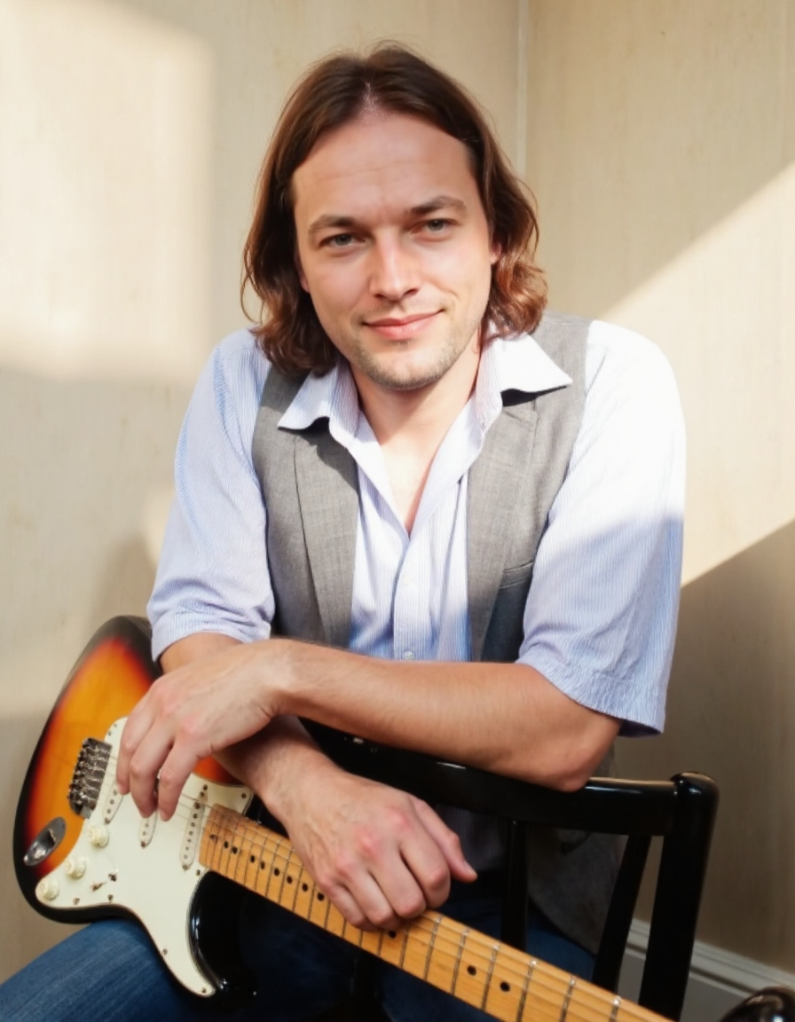 <lora:DAVID_GILMOUR:1>This photograph features a man sitting in a relaxed pose, leaning slightly forward with his arms crossed. He has shoulder-length, dark brown hair that falls naturally around his face. The man is wearing a light blue, short-sleeved button-up shirt with vertical stripes, paired with a grey, sleeveless vest. He is also wearing blue jeans. His expression is calm and slightly smiling.
In front of him, on a black chair, lies an electric guitar with a distinctive sunburst finish, transitioning from a dark brown at the head to a lighter yellow at the body. The guitar's neck is positioned towards the man, with the body resting on the chair. The man's right hand is placed on the guitar, suggesting he may be a musician or enthusiast.
The background consists of a plain, light beige wall, providing a neutral backdrop that highlights the subject. The lighting is soft and even, casting gentle shadows and highlighting the textures of the man's clothing and the guitar. The overall mood of the photograph is casual and intimate, capturing a moment of relaxed enjoyment.
