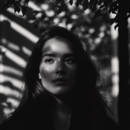 cinematic film still of <lora:casting shadow style v2:1>
A cucoloris patterned illumination casting a tree branch shadow on a modeling woman with long hair standing in front of a tree,1girl,solo,long hair,monochrome,upper body,greyscale,blurry,lips,depth of field,blurry background,realistic,nose,cinematic,film,filmic,casting shadow,venetian blinds casting shadow light,shadow on face,face partially covered in shadow,different shadow,window casting shadow light,cinematography,detailed,detailed background,detailed face,high quality,8k,cuculoris,kookaloris,cookaloris or cucalorus,light modifier,different light pattern,creative light,unique shadow , casting shadow style, shallow depth of field, vignette, highly detailed, high budget, bokeh, cinemascope, moody, epic, gorgeous, film grain, grainy