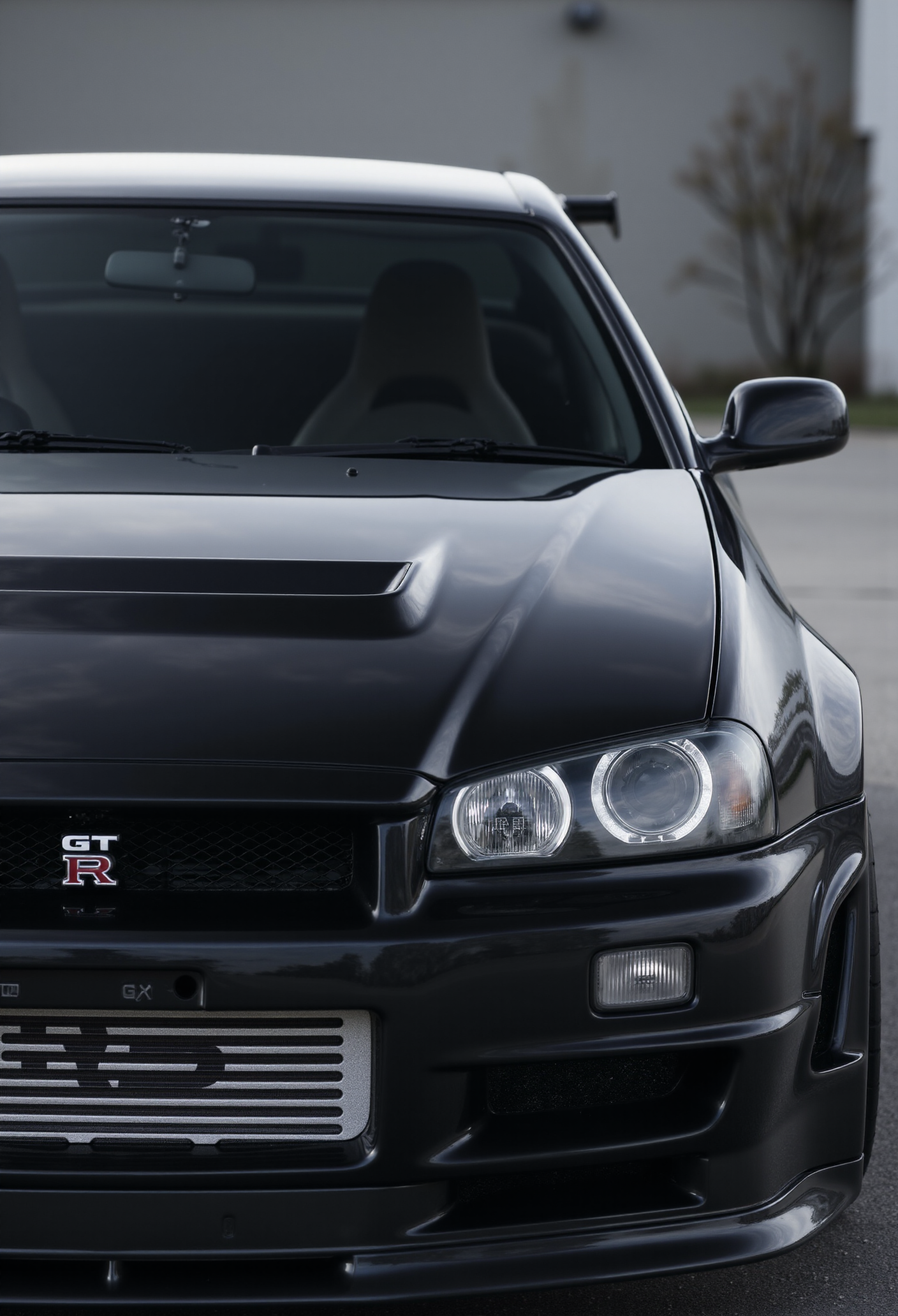 <lora:Nissan_Skyline_GT-R_R34:0.8> A slightly close shot of a modified Nissan Skyline GT-R R34 in all its shining glory. Mirror-like, flossy finish.