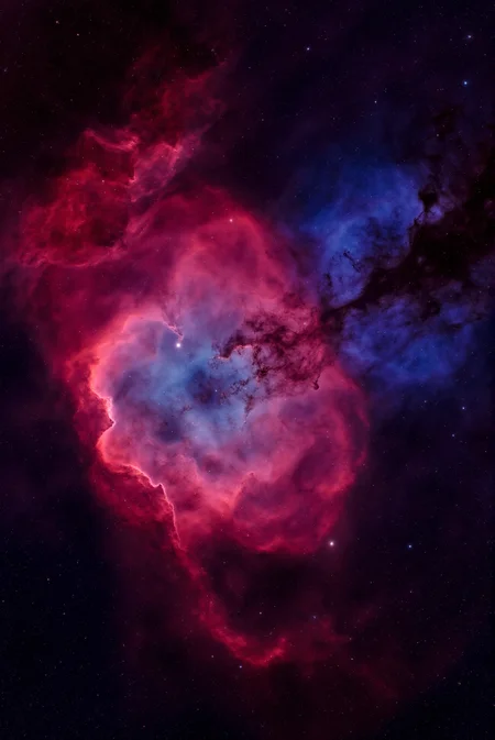 <lora:Vibrant_Nebula_2:0.8> VibrantNebula style.
The image is a high-resolution photograph of a nebula, specifically the Carina Nebula, captured in space. The nebula appears as a vast, swirling cloud of interstellar gas and dust, with colors that range from deep reds, purples, and blues. The central region is dominated by a bright, swirling red cloud, which transitions into a deep blue area around the edges. The red portions resemble a swirling, turbulent sea of clouds, with some areas appearing denser and darker, indicating more concentrated gas and dust. The blue regions, on the other hand, are less dense and more transparent, allowing more stars to shine through. Scattered throughout the nebula are numerous stars, some of which are bright and visible, while others are dimmer.