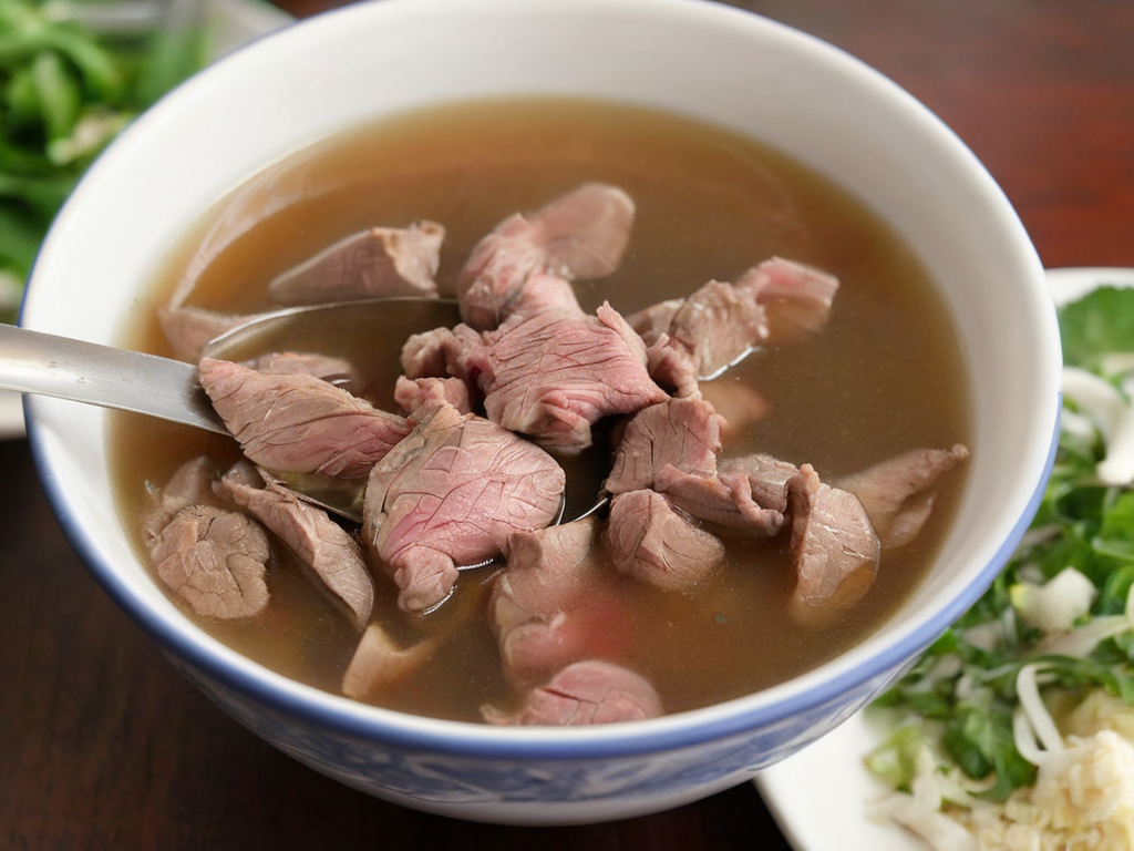 A high-resolution, hyper-realistic image of a bowl of Sweetbeefsoup. This traditional dish features a clear, sweet broth that is the star of the dish. The broth is simmered to perfection, with a hint of sweetness that tantalizes the taste buds. A subtle hint of pink is added to the broth, giving it a unique and appealing look. The soup is garnished with fresh ginger and scallions, which are evenly sprinkled throughout the broth, adding a pop of color and enhancing the flavor. It's served in a traditional ceramic bowl, placed on a rustic wooden table. The scene is set in a cozy kitchen, with all elements in sharp focus, creating a clear and detailed image. The lighting should be warm and inviting, highlighting the appetizing qualities of the Sweetbeefsoup and the homely atmosphere of the setting,<lora:beefsoup:0.75>
