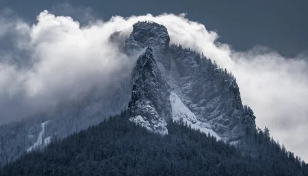amazing photograph of gorgeous view, award winning, breathtaking, photo of the year, 4k, hyperrealistic, dramatic lighting <lora:Earth35_000010:0.4> <lora:Landscape_Unleashed:0.8>
A tall mountain with a forest on its side, obscured by mist and fog. The clouds are white, making the scene look like a wintery landscape. Several trees can be seen in front of the mountains, with some appearing closer to the viewer while others seem further away.