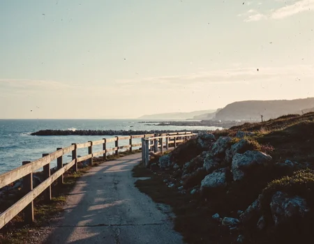 GroovyAesthetica, 1970s style, Using a 35mm lens, take a Kodachrome photograph. Scenic photo. 
<break> 
A peaceful, natural setting with a serene, ocean view, a worn, wooden pier, and a warm, sunset glow, surrounded by a calm, sea breeze.