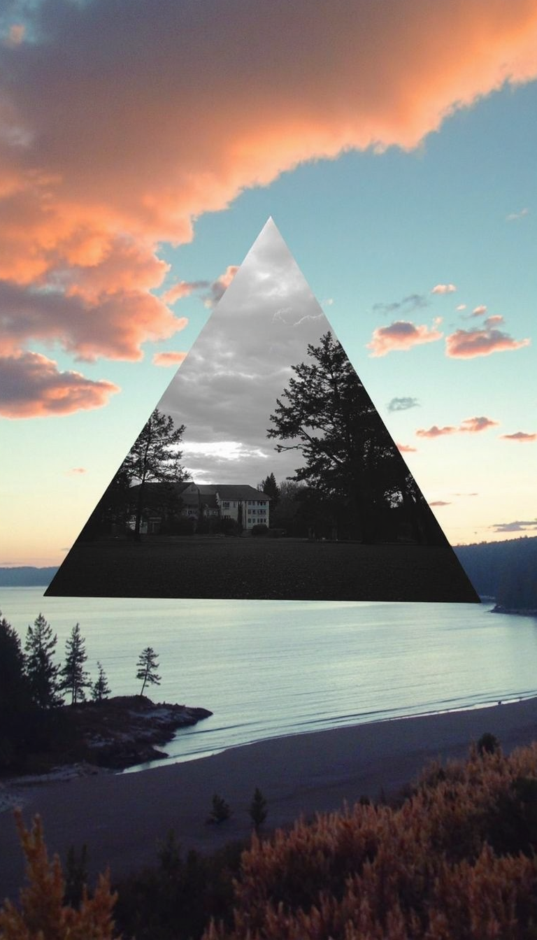 landscape image with realistic, natural colors. In the center of the sky, there is a large triangle showing an inverted black-and-white scene of trees and buildings by a lake, with a cloudy sky overhead. The mirror triangle contrasts with the vibrant, natural tones of the landscape around it, including a shoreline with water, trees, and plants on a calm beach. The scene outside the triangle has realistic colors, like a peaceful sunset with soft oranges and blues in the sky. The image has soft edges and a painterly texture, emphasizing the contrast between the black-and-white triangle and the realistic colors of the environment, amateurish quality, underexposed, eerie atmosphere
