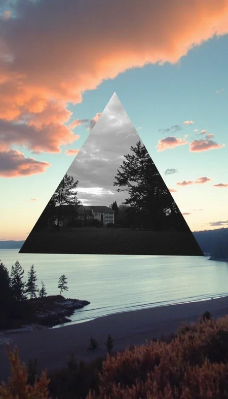 landscape image with realistic, natural colors. In the center of the sky, there is a large triangle showing an inverted black-and-white scene of trees and buildings by a lake, with a cloudy sky overhead. The mirror triangle contrasts with the vibrant, natural tones of the landscape around it, including a shoreline with water, trees, and plants on a calm beach. The scene outside the triangle has realistic colors, like a peaceful sunset with soft oranges and blues in the sky. The image has soft edges and a painterly texture, emphasizing the contrast between the black-and-white triangle and the realistic colors of the environment, amateurish quality, underexposed, eerie atmosphere
