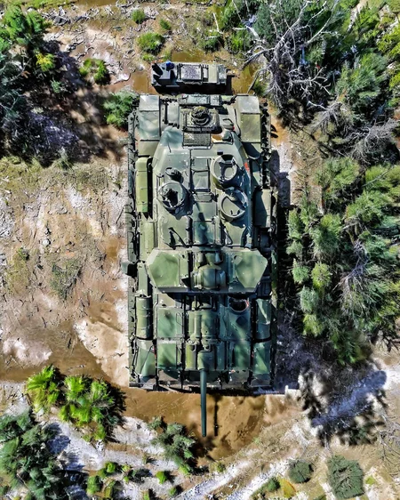 vertical perspective aerial photography, Military_tank, aerial_view, natural_landscape, armored_fighting_vehicle, tracked_vehicle, military_equipment<lora:sky:0.8>